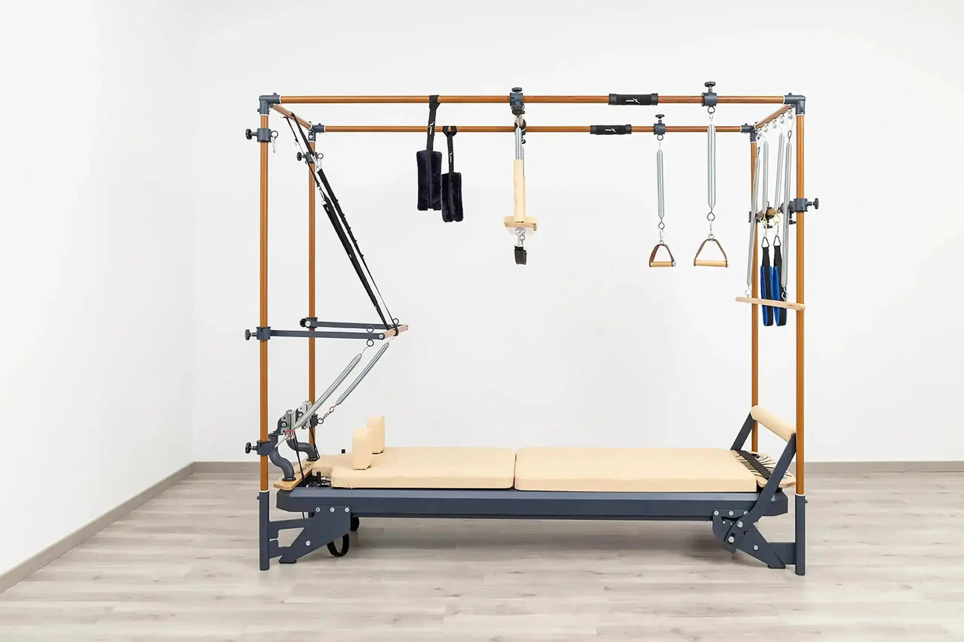 Side view of the HEGREN Cadillac Reformer TALMA 62CR showcasing its steel frame and beige upholstery.