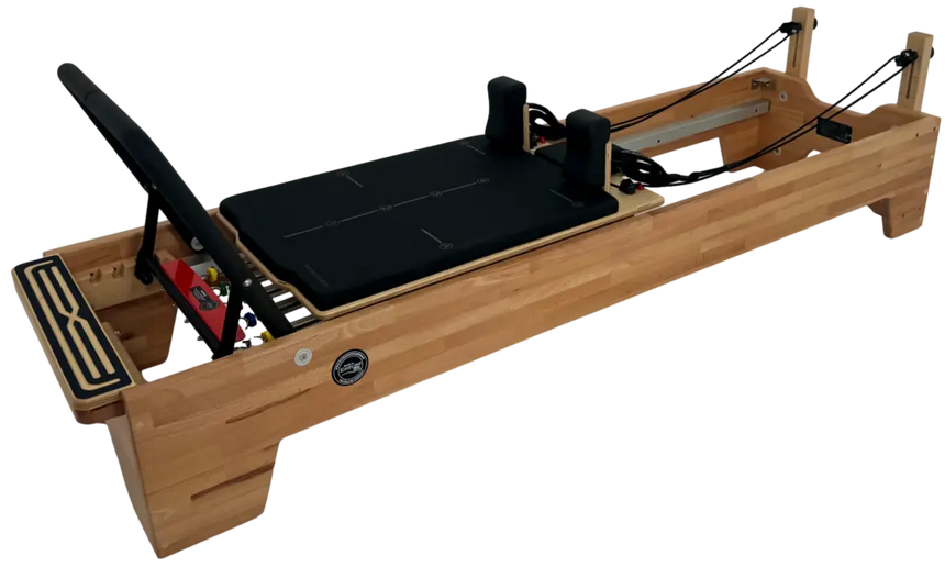 Wooden Pilates reformer machine on a white background