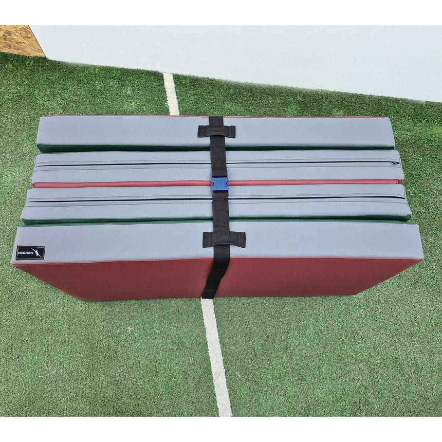 HEGREN Foldable Pilates Mat in blue, featuring high-density foam and synthetic leather upholstery, folded for easy transport.