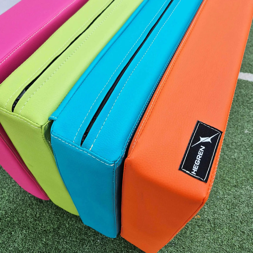 HEGREN Foldable Pilates Mat in blue, featuring high-density foam and synthetic leather upholstery, folded for easy transport.