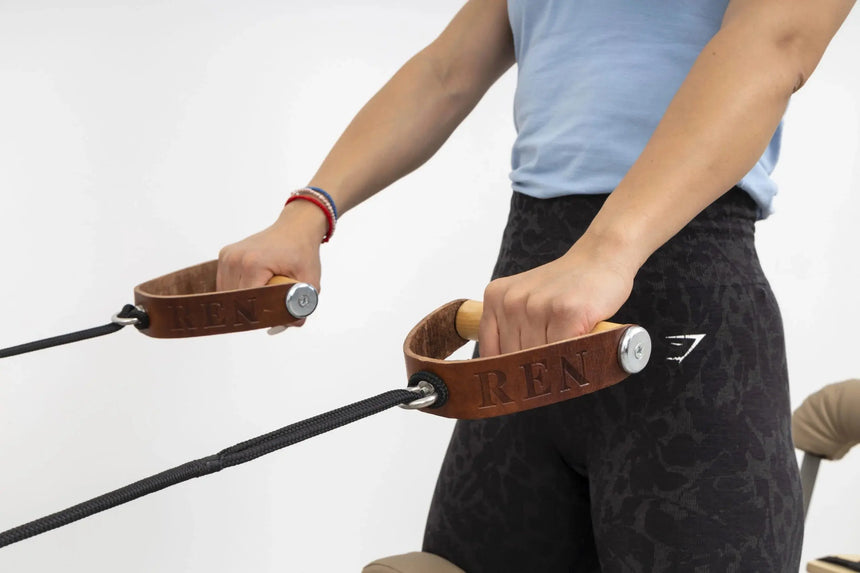 HEGREN Leather Wood Handles designed for Pilates equipment, featuring durable leather straps and smooth wooden grips.