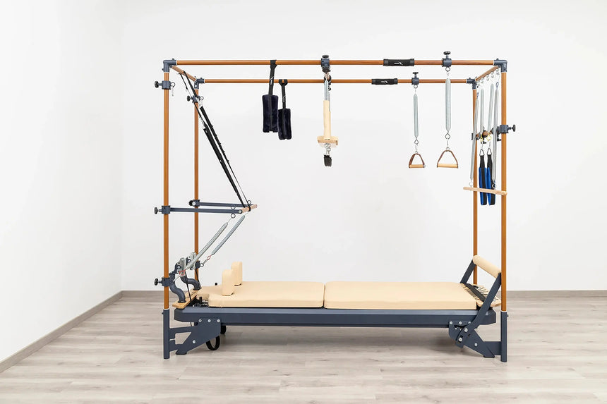 Side view of the HEGREN Cadillac Reformer TALMA 62CR showcasing its steel frame and beige upholstery.