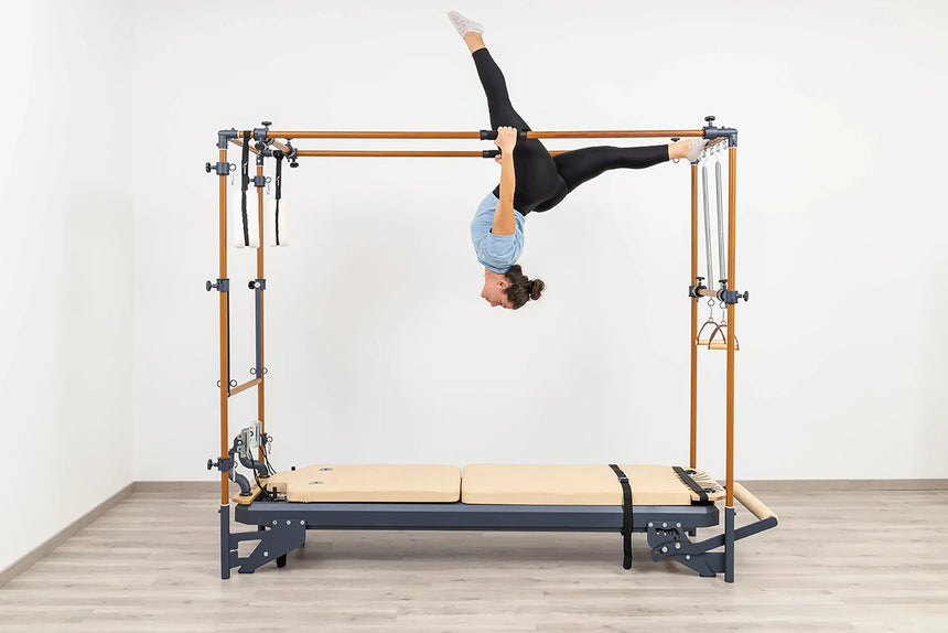 Side view of the HEGREN Cadillac Reformer TALMA 62CR showcasing its steel frame and beige upholstery.