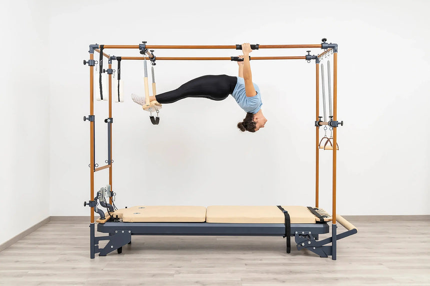 Side view of the HEGREN Cadillac Reformer TALMA 62CR showcasing its steel frame and beige upholstery.