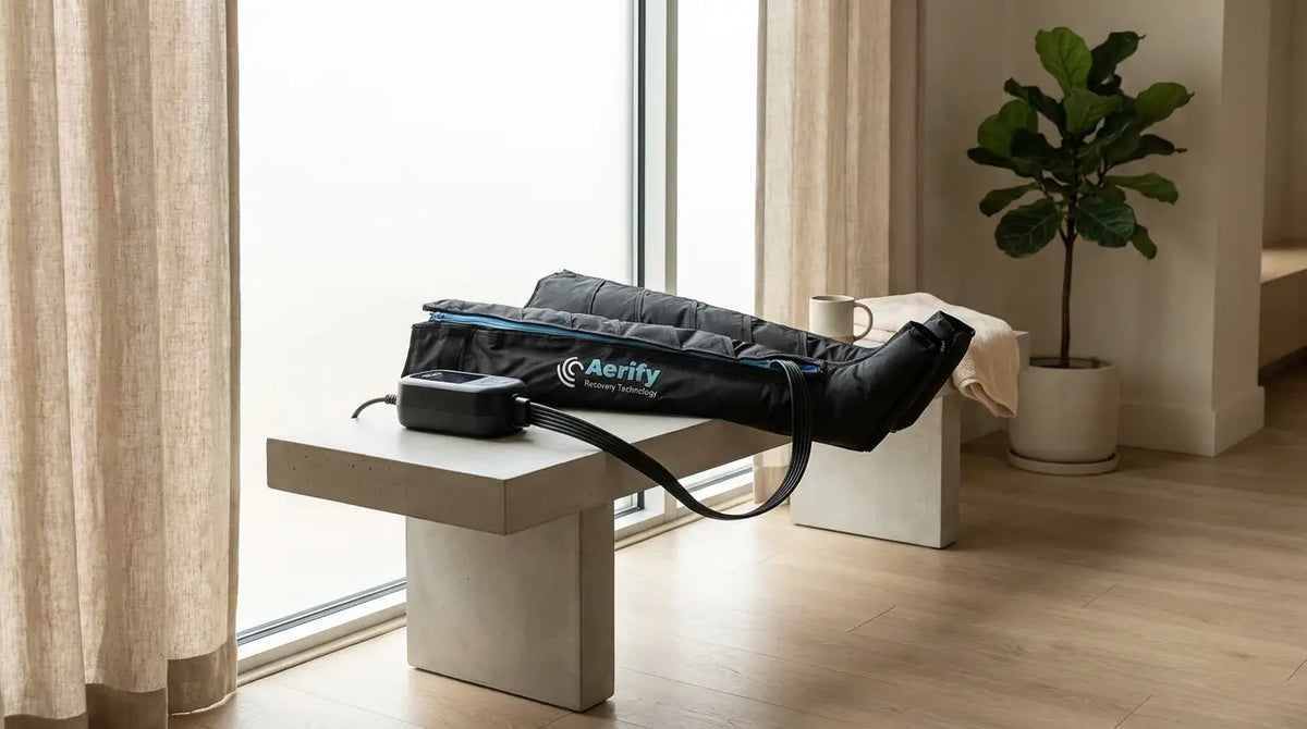 Pneumatic compression recovery boots on a bench in a modern recovery studio