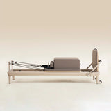 Elina Pilates Nubium Moka Edition Reformer in Seitenansicht mit Sitzbox auf dem Wagen