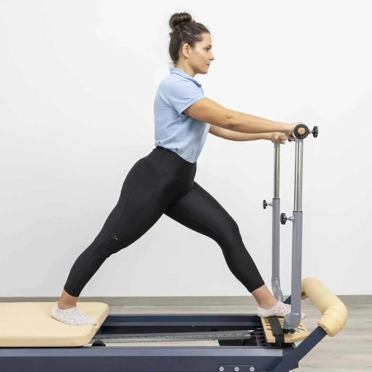 HEGREN Stability Bar Stand mounted on a wall, designed to securely hold the Stability Bar when not in use.