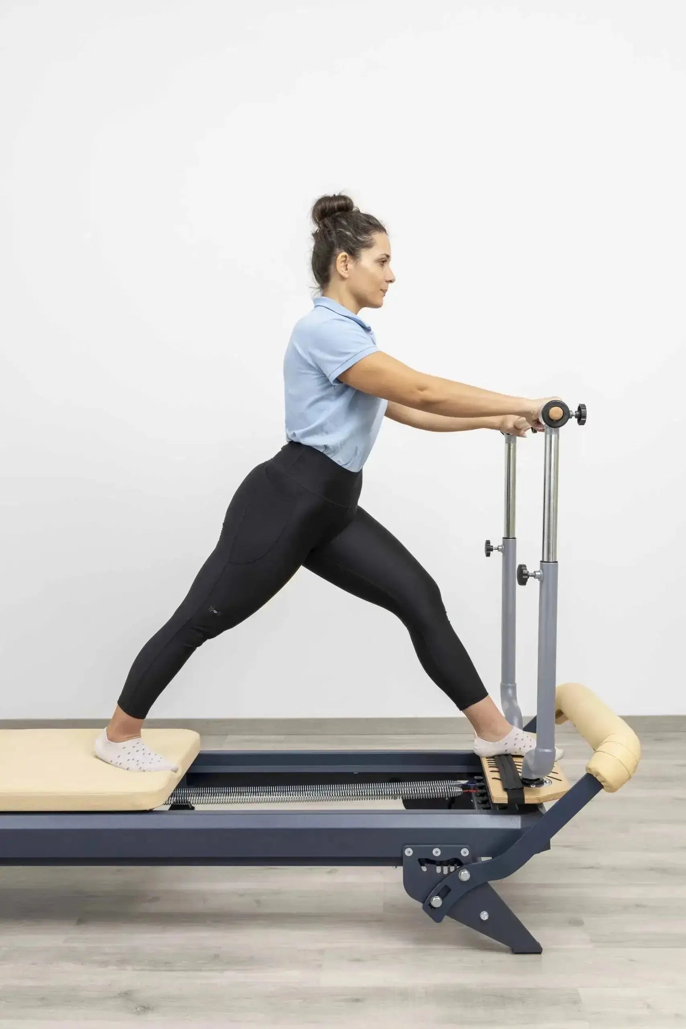 HEGREN Stability Bar Stand mounted on a wall, designed to securely hold the Stability Bar when not in use.