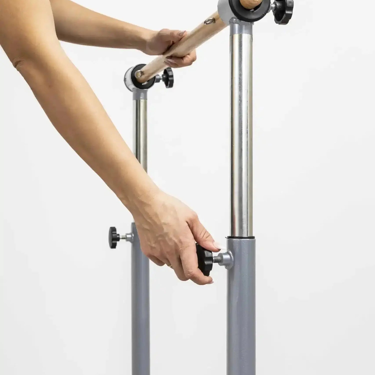 HEGREN Stability Bar Stand mounted on a wall, designed to securely hold the Stability Bar when not in use.