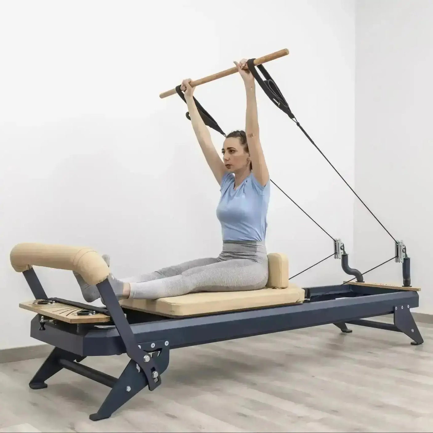 HEGREN Pilates Wooden Stick (1.10m) designed to enhance balance and flexibility during Reformer exercises