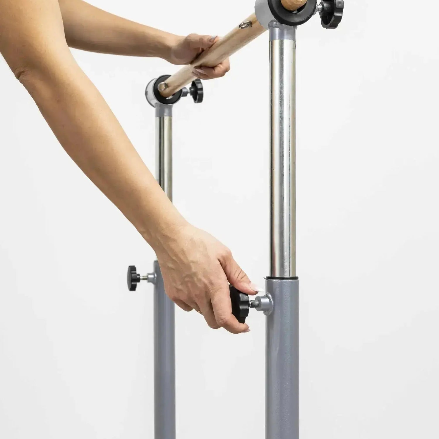 HEGREN Stability Bar attached to a Pilates Reformer, enabling safe execution of standing exercises like side and front splits.