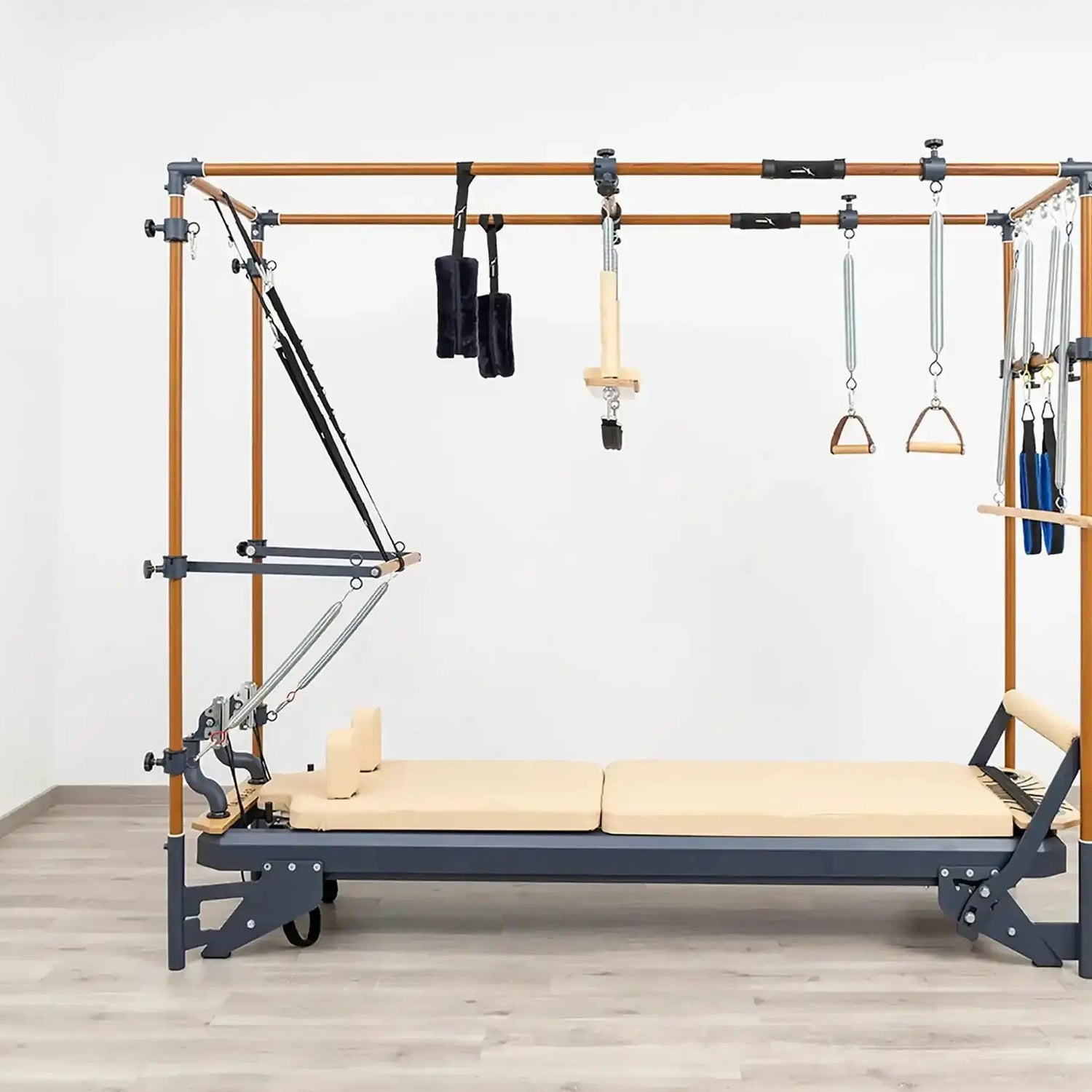 Side view of the HEGREN Cadillac Reformer TALMA 62CR showcasing its steel frame and beige upholstery.