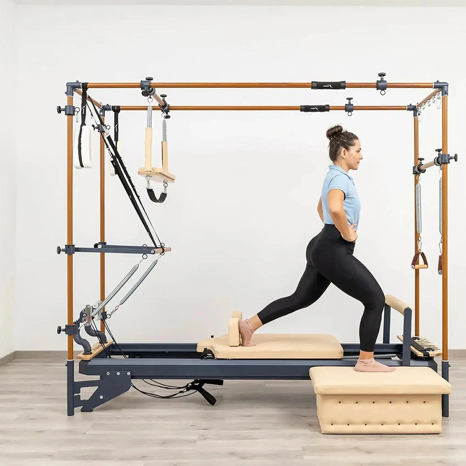 Side view of the HEGREN Cadillac Reformer TALMA 62CR showcasing its steel frame and beige upholstery.