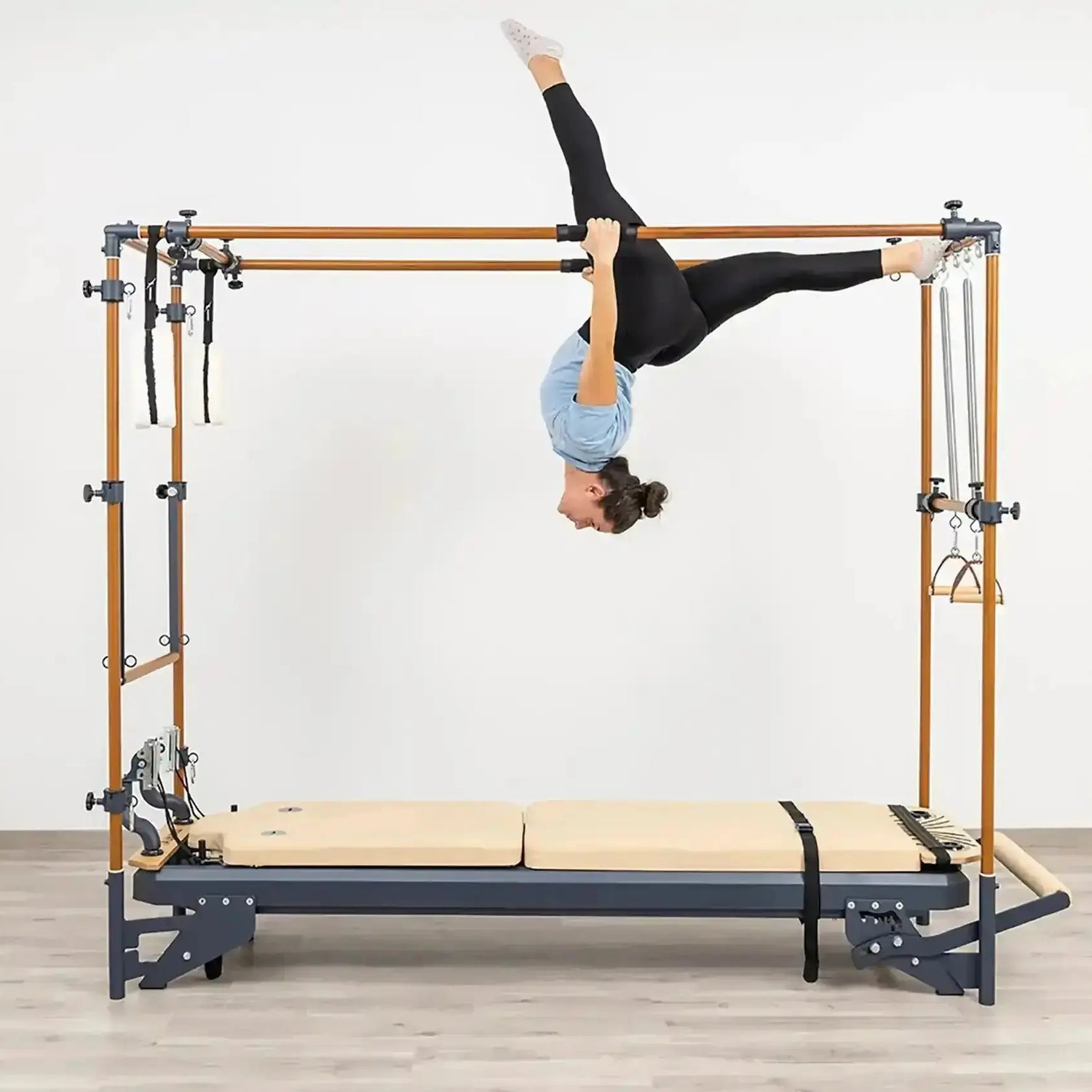 Side view of the HEGREN Cadillac Reformer TALMA 62CR showcasing its steel frame and beige upholstery.