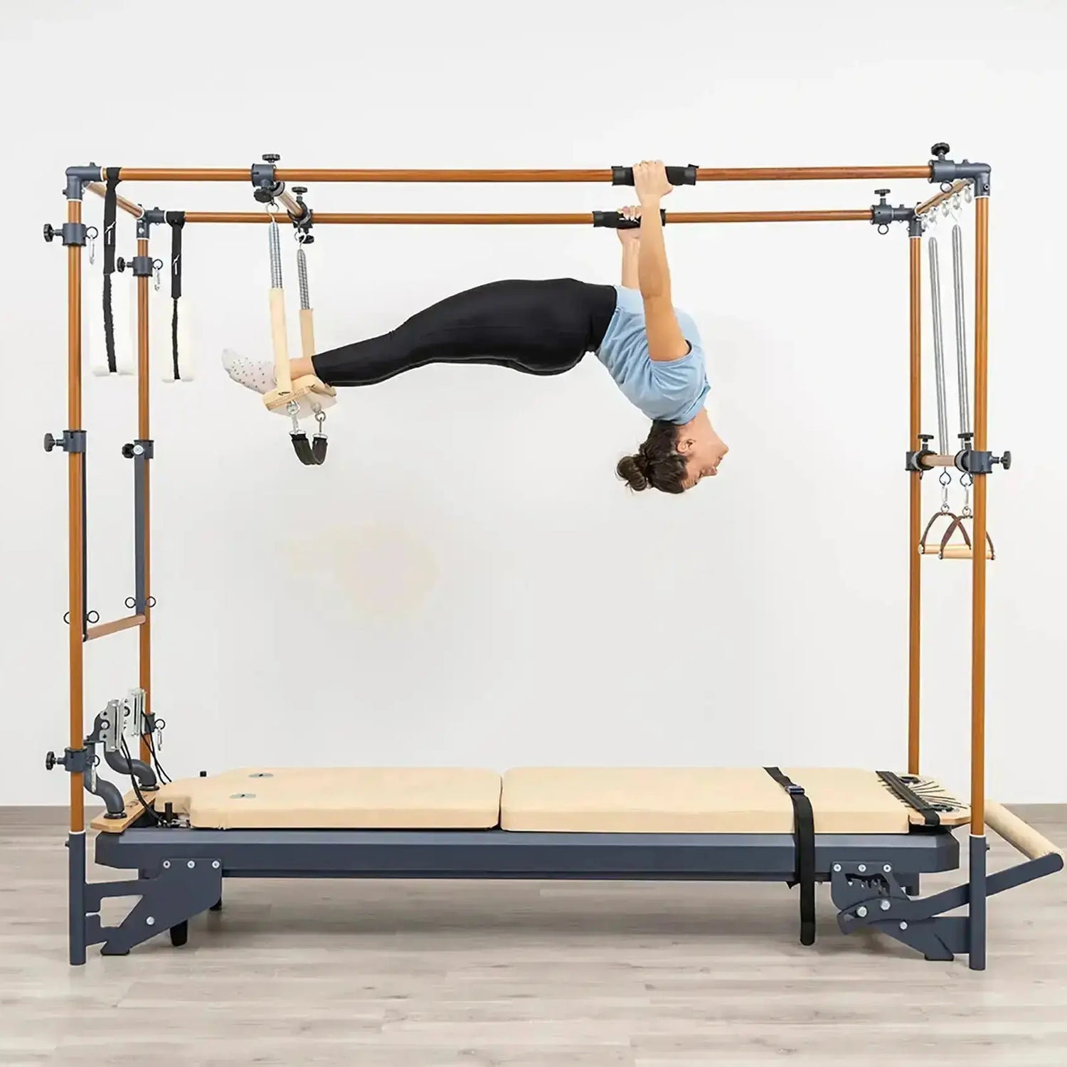 Side view of the HEGREN Cadillac Reformer TALMA 62CR showcasing its steel frame and beige upholstery.