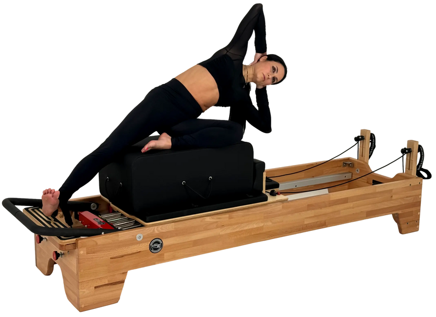 Woman using a Pilates reformer machine on a white background