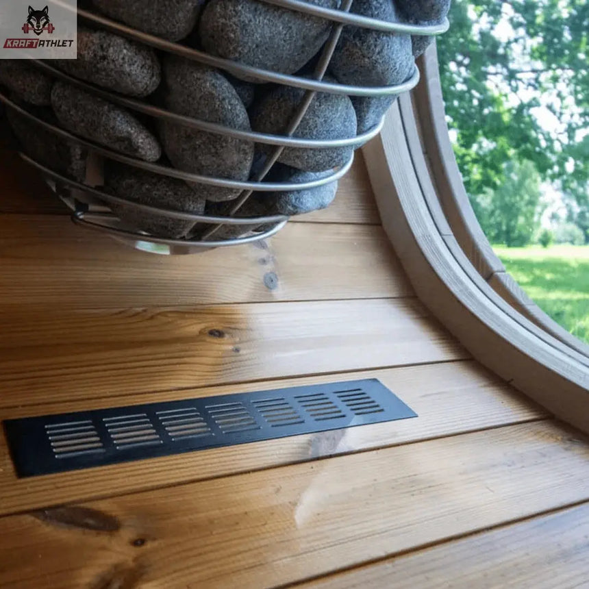 Decorative stone basket on a wooden surface with a window in the background