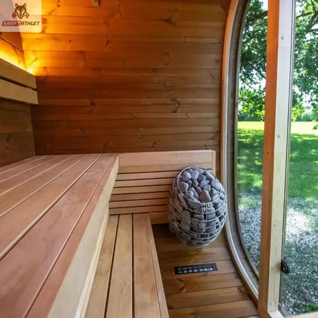 Wooden sauna interior with a large round window showing greenery outside.
