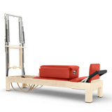 Elina Pilates Classic Reformer mit Tower aus Ahornholz mit Polstern in Rot, Seitenansicht vor weißem Hintergrund