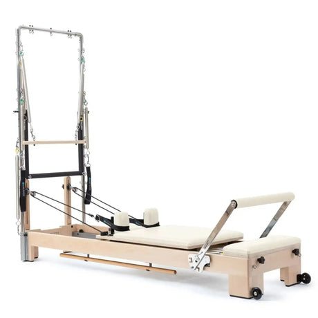 Elina Pilates Lignum Reformer mit Tower aus Holz mit Polstern in Elfenbein, Schrägansicht mit Tower