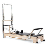 Elina Pilates Lignum Reformer mit Tower aus Holz mit Polstern in Schwarz, Schrägansicht mit Tower
