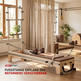 Elina Pilates Master Instructor Reformer mit Tower aus Ahornholz in einem hellen Pilates-Studio mit Holz und Leinen