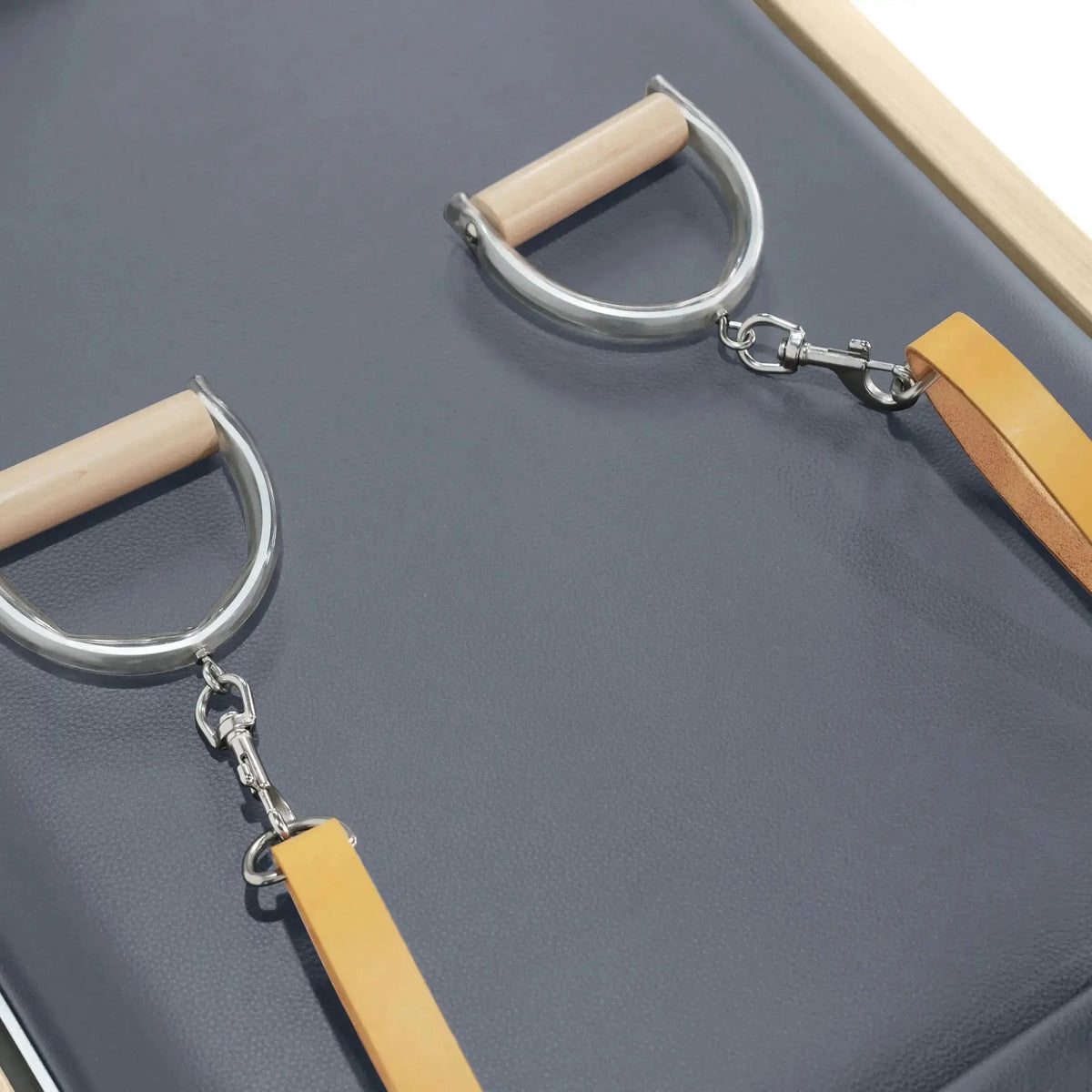 Elina Pilates Reformer Cadillac Klassisch Naturholz, Detail der Holzgriffe mit Karabinern auf grauem Polster