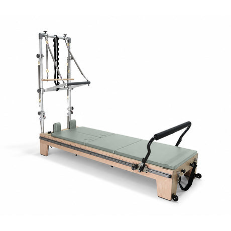 Elina Pilates Twin Reformer with eucalyptus-colored padding, side view with tower on a white background