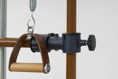 Hegren Leder-Holz-Griffe, Detail eines Griffs am Metallkarabiner vor einer Holzsäule