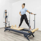 Side view of the HEGREN TALMA 62 Pilates Reformer showcasing its steel frame and beige upholstery.