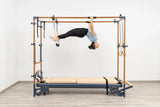 Side view of the HEGREN Cadillac Reformer TALMA 62CR showcasing its steel frame and beige upholstery.