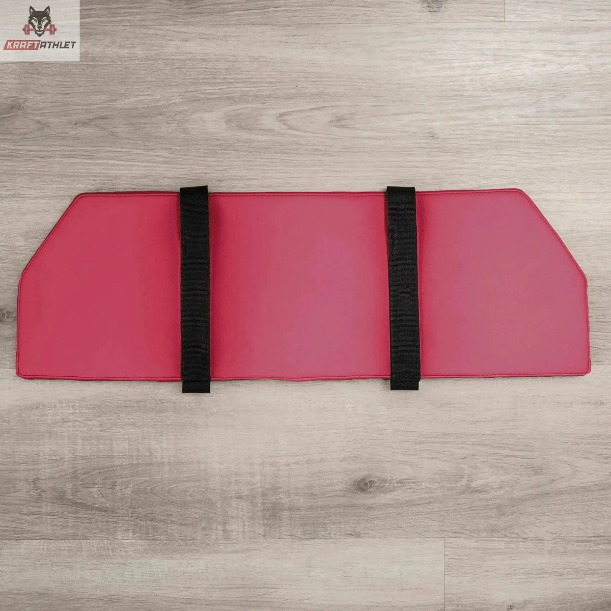 Hegren Platform Pad TALMA Reformer-Auflage, Draufsicht in Pink mit Fixiergurten auf Holzboden