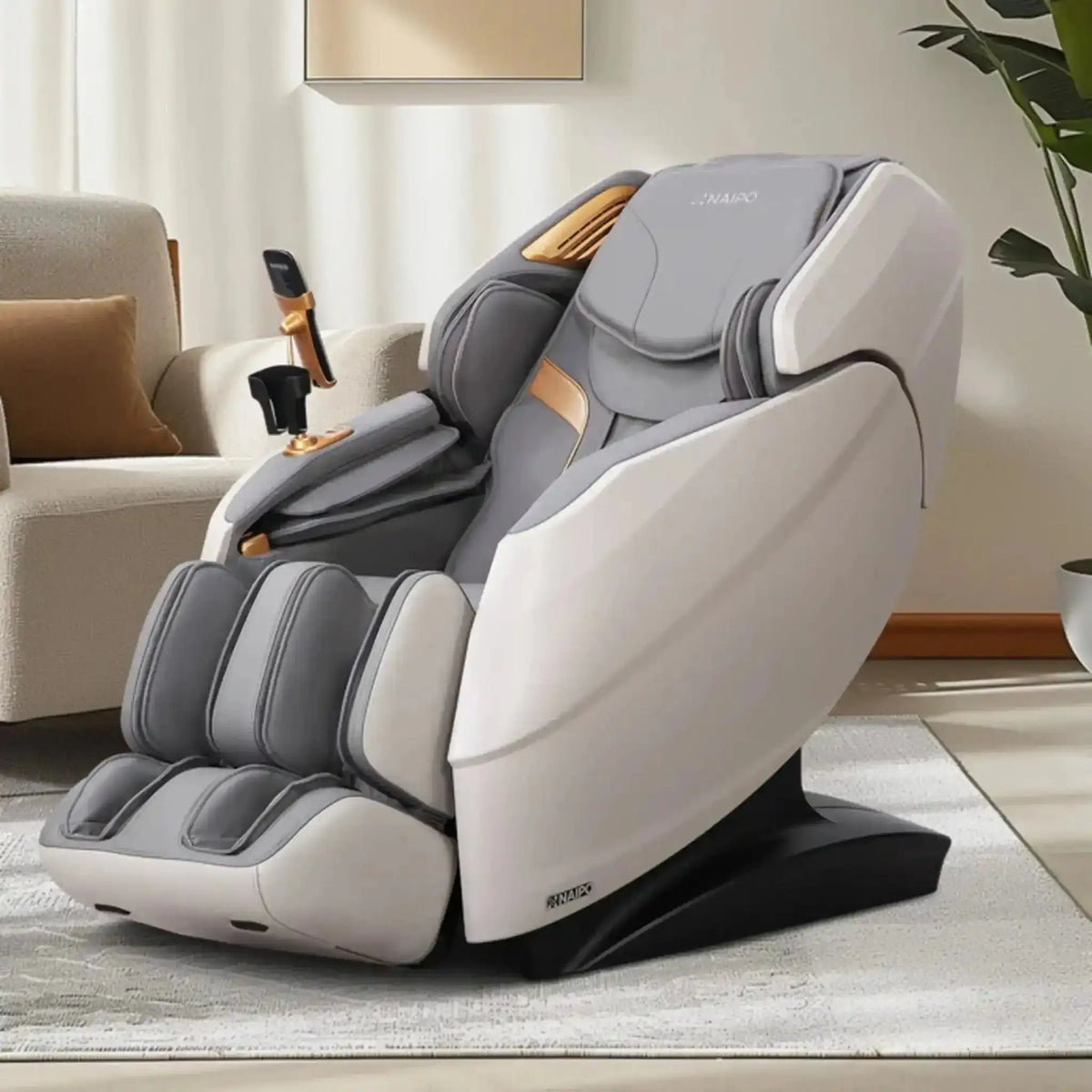 NAIPO R50 Massagesessel in Grau, Schrägansicht im hellen Wohnzimmer neben einer Zimmerpflanze