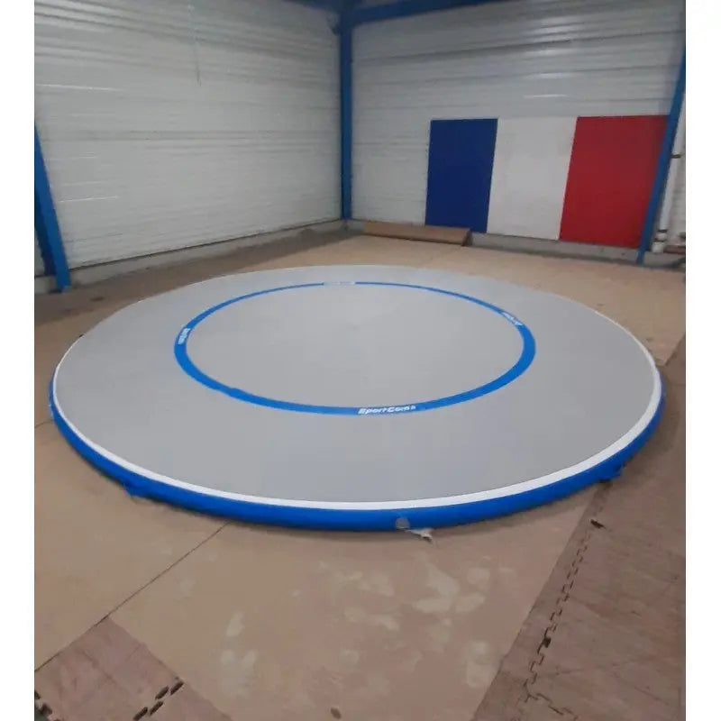 SportCom Aqua-Ringmatte für Kampfsport in Grau und Blau aufgebaut in einer Halle, Schrägansicht