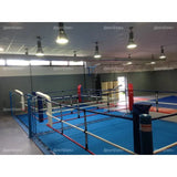 SportCom Doppel-Boxring Bodenpfosten mit Spannseilen, in einer Halle mit roter und blauer Ecke