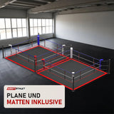 SportCom Doppel-Boxring mit Spannseilen und Stahlpfosten in einer hellen Kampfsporthalle