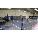 SportCom Ecofix Boxring bodenmontiert in einer Trainingshalle, weite Ansicht mit gelben Ecken