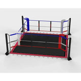 SportCom Ecofix Boxring mit Spannseil-Plane, Schrägansicht mit schwarzer Plane, roter Kante und blauer Ecke