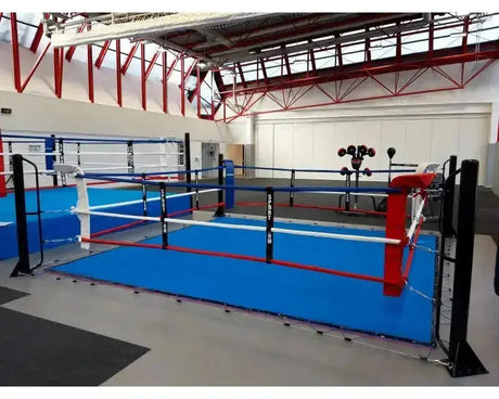 SportCom Ecofix Boxring mit Spannseil-Plane in einer Sporthalle, blaue Plane mit weißen und roten Seilen