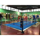 SportCom Ecofix Doppel-Boxring mit Aluminiumrand, in einem Boxgym mit grüner Wand und blauem Boden