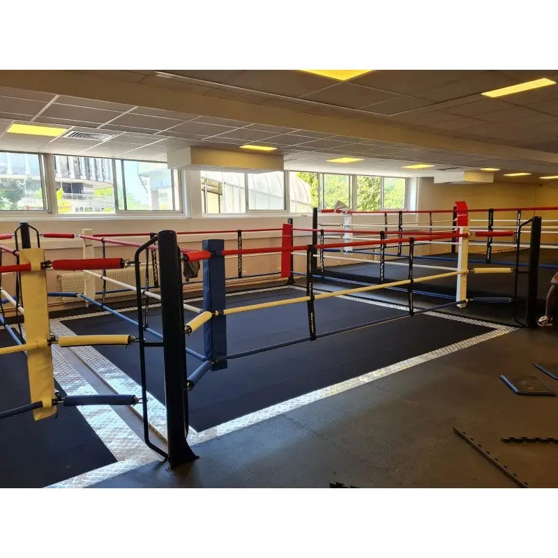 SportCom Ecofix Doppel-Boxring mit Aluminiumrand, in einer Trainingshalle mit gelben und schwarzen Pfosten