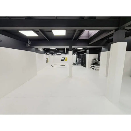 SportCom Flexi-Roll Ringermatte von Dollamur, weiße Fläche in einem Studio mit dunkler Decke
