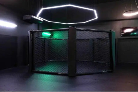 SportCom MMA-Käfig Oktagon zur Bodenmontage, in einem dunklen Studio mit grünem Licht und Lichtring
