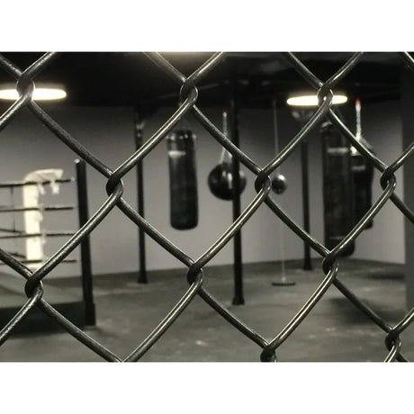 SportCom MMA-Paneel mit Tür als Detail des Maschendrahts mit Boxsäcken im Hintergrund