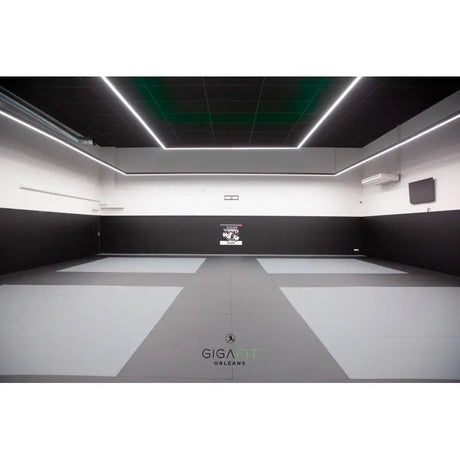 SportCom MMA-Tatami Glattfinish 1 × 1 m, 5 cm, glatte Unterseite, helles Studio mit grau-weißer Mattenfläche