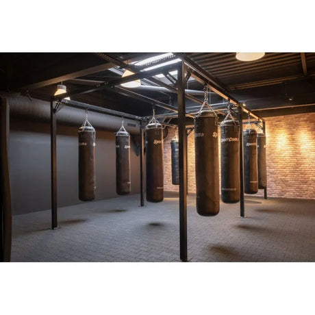 SportCom Modulare Sandsack-Station, in einem Gym mit Backsteinwand und Holzdecke