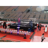 SportCom Pro-Wettkampf-Boxring mit 1 m Podium, in einer Arena beim Aufbau mit Besuchern