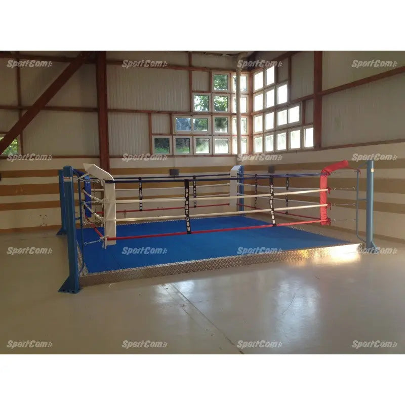 SportCom Trainingsboxring mit 15 cm Podium, in einer Halle mit Holzwand und blauem Boden
