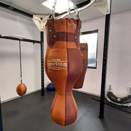 SportCom Vintage 3-in-1-Sandsack Echtleder in einem Trainingsraum mit weiteren Säcken und schwarzem Gestell
