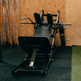 Titanium Strength Black Series Hackenschmidt Kniebeuge Maschine – Aufnahme im Studio vor Holzwand mit Schulterpolstern